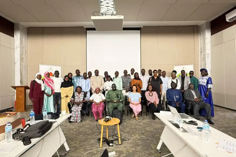 Workshop participants stand and sit together for a group photo, Burkina Faso